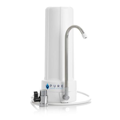 White slimline bench top water filter with chrome curved faucet and black valve attachment.